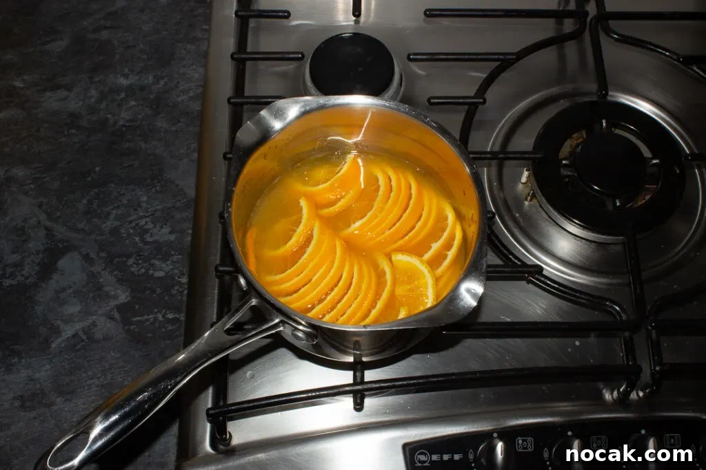 Sticky Orange Glaze Cake Recipe with Zesty Citrus Flavor 11 Semicircle orange slices, orange juice, sugar and water in a saucepan over a medium heat.