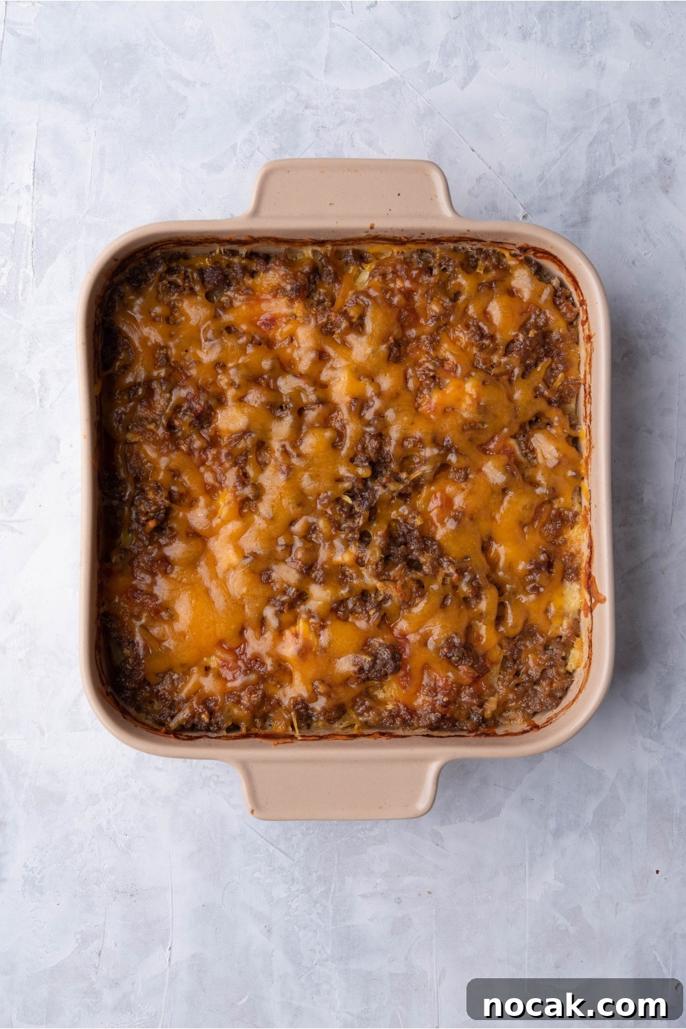 Hearty Hamburger and Potato Casserole with Canned Soup 8 Brown baking dish with unbaked hamburger potato casserole.