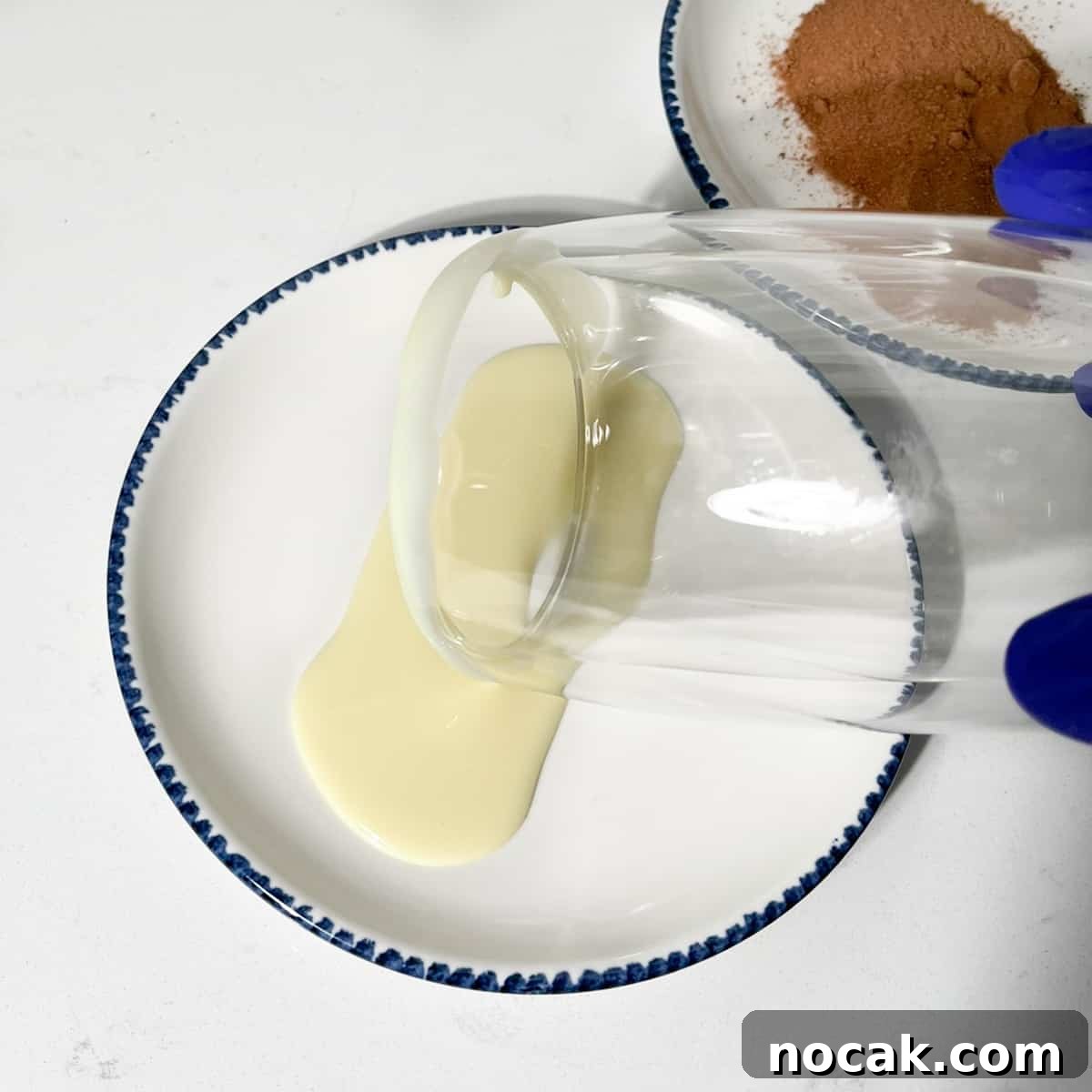 Iced Milo Dinosaur with Condensed Milk: Creamy Milo Drink Recipe 5 Rolling the edge of the glass in condensed milk.