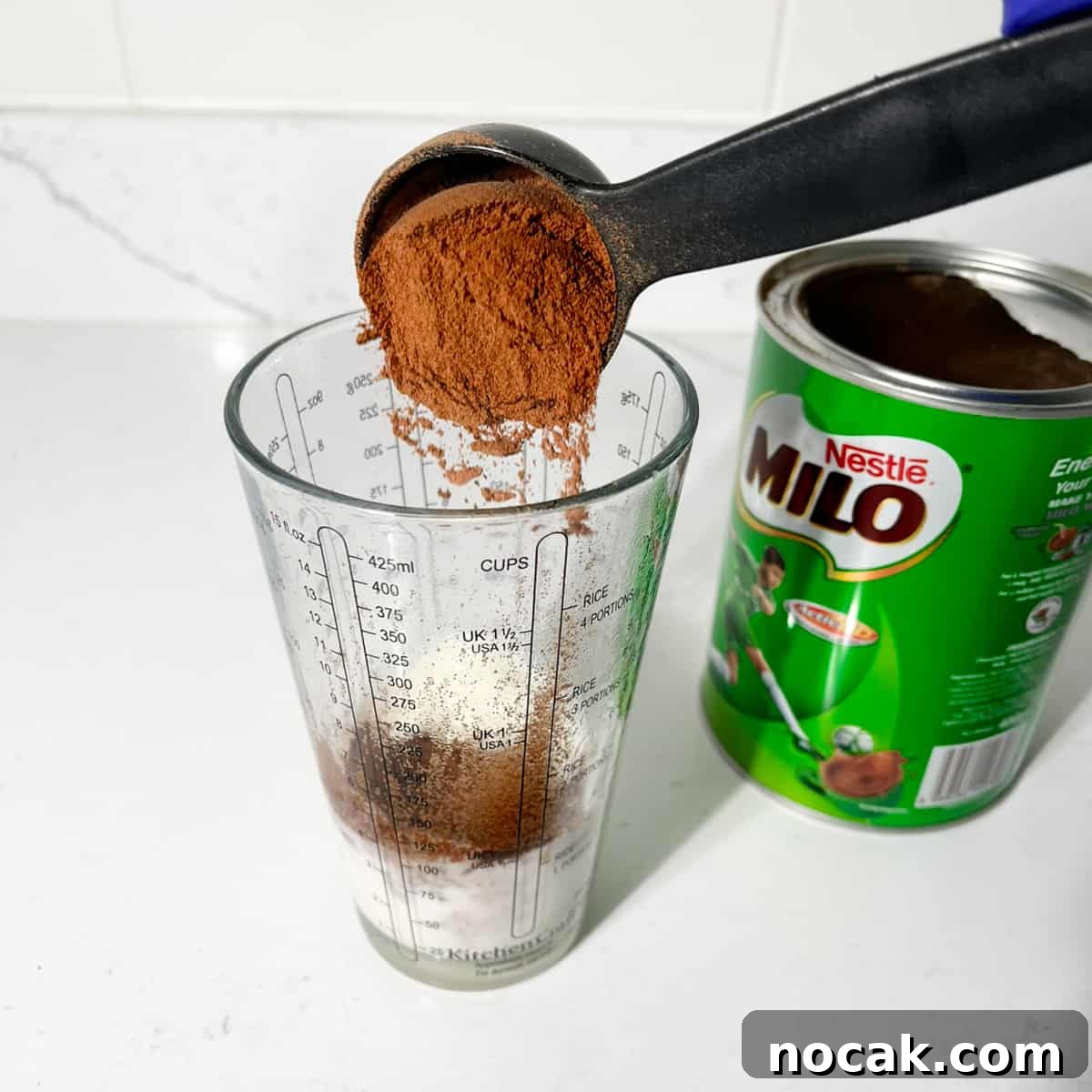Iced Milo Dinosaur with Condensed Milk: Creamy Milo Drink Recipe 8 Adding milo to boiled milk.