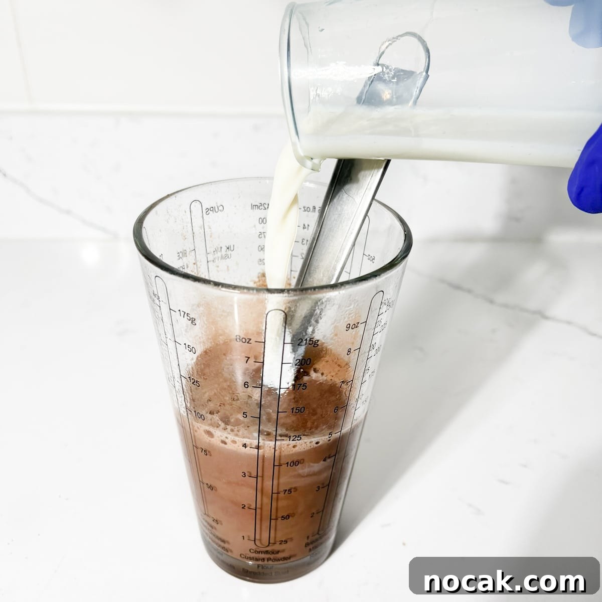 Iced Milo Dinosaur with Condensed Milk: Creamy Milo Drink Recipe 9 Adding the rest of the milk to the measuring cup.