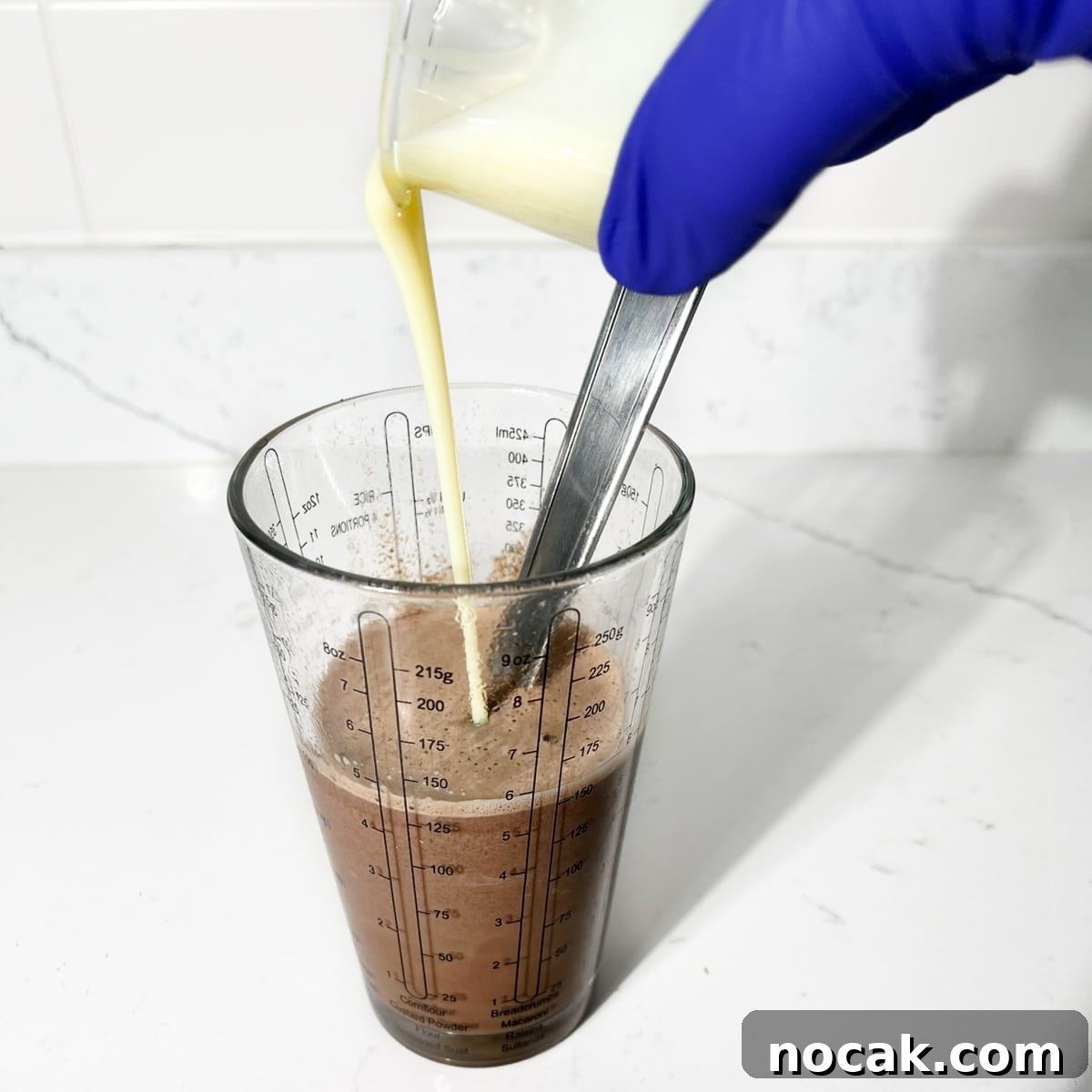 Iced Milo Dinosaur with Condensed Milk: Creamy Milo Drink Recipe 10 Pouring condensed milk into the milo-dinosaur.