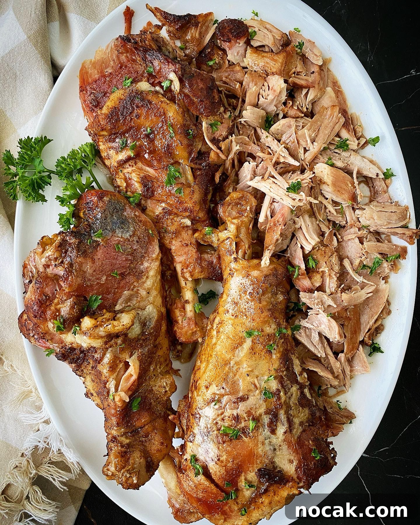 Slow Cooker Turkey Legs Recipe with Step-by-Step Video 2 overhead shot of cooked slow cooker turkey legs on a white platter