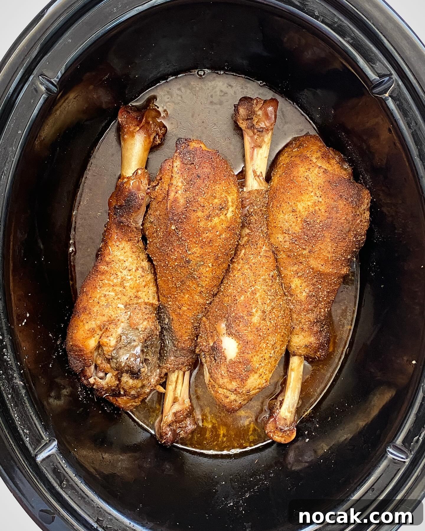 Slow Cooker Turkey Legs Recipe with Step-by-Step Video 5 overhead shot of cooked turkey legs in a black slow cooker