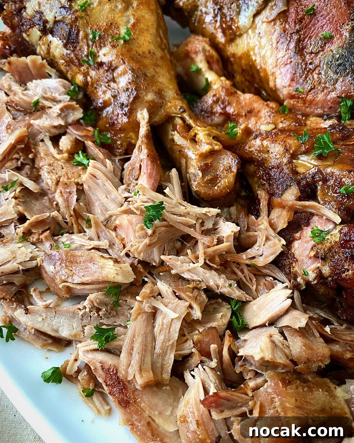 Slow Cooker Turkey Legs Recipe with Step-by-Step Video 9 overhead shot of cooked, shredded slow cooker turkey legs on a white platter