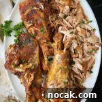 overhead shot of cooked slow cooker turkey legs on a white platter