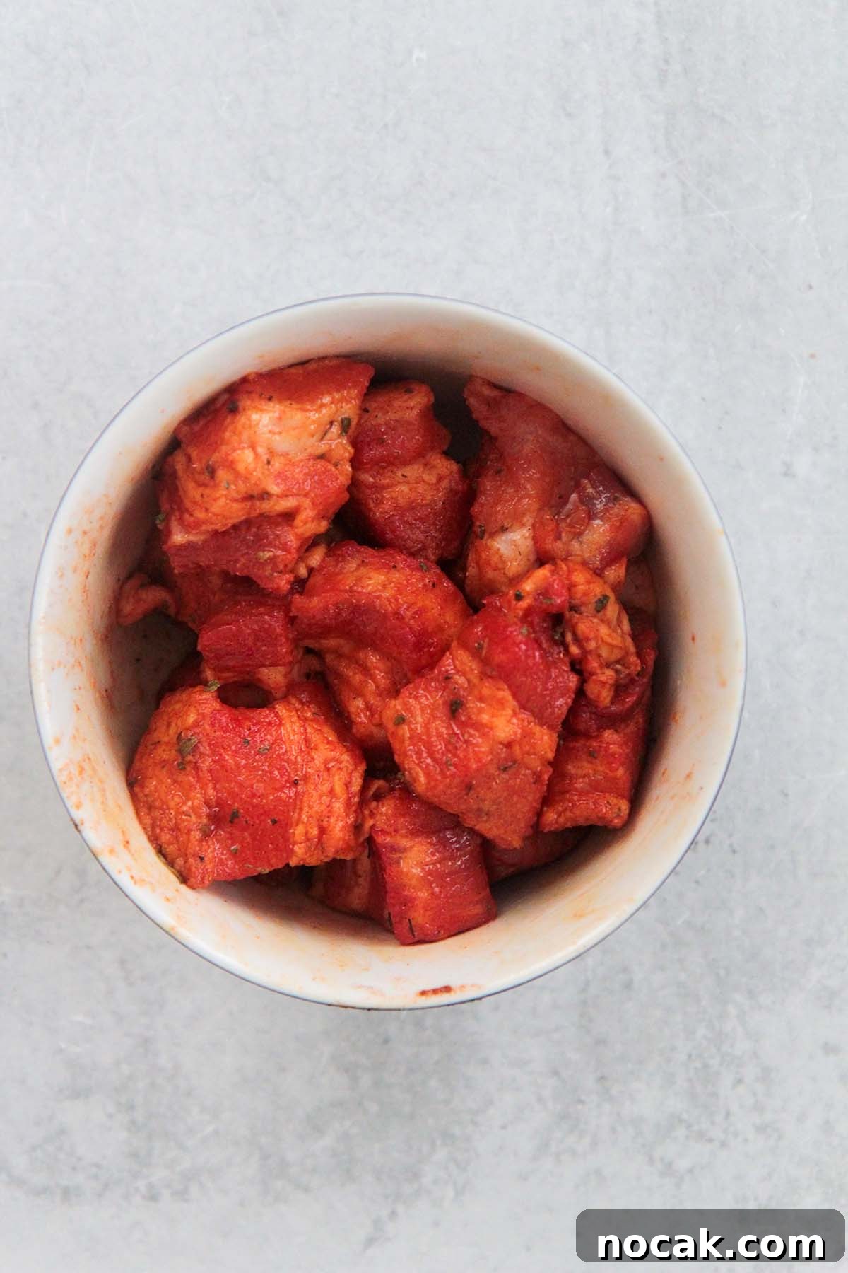 Crispy Air Fryer Pork Belly Recipe: Perfect Crackling in Minutes 4 marinated raw pork belly in a bowl.