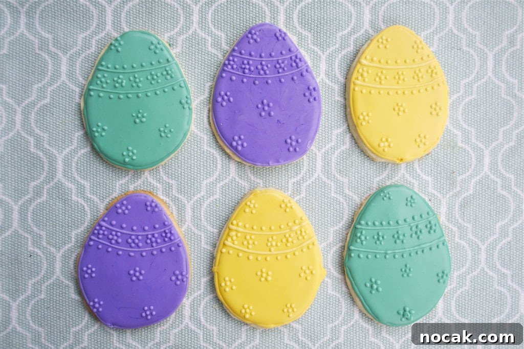Gluten-Free Easter Sugar Cookies: Soft, Festive Egg Cookies 52 Sugar cookies decorated with green, yellow and purple royal icing to look like Easter eggs.