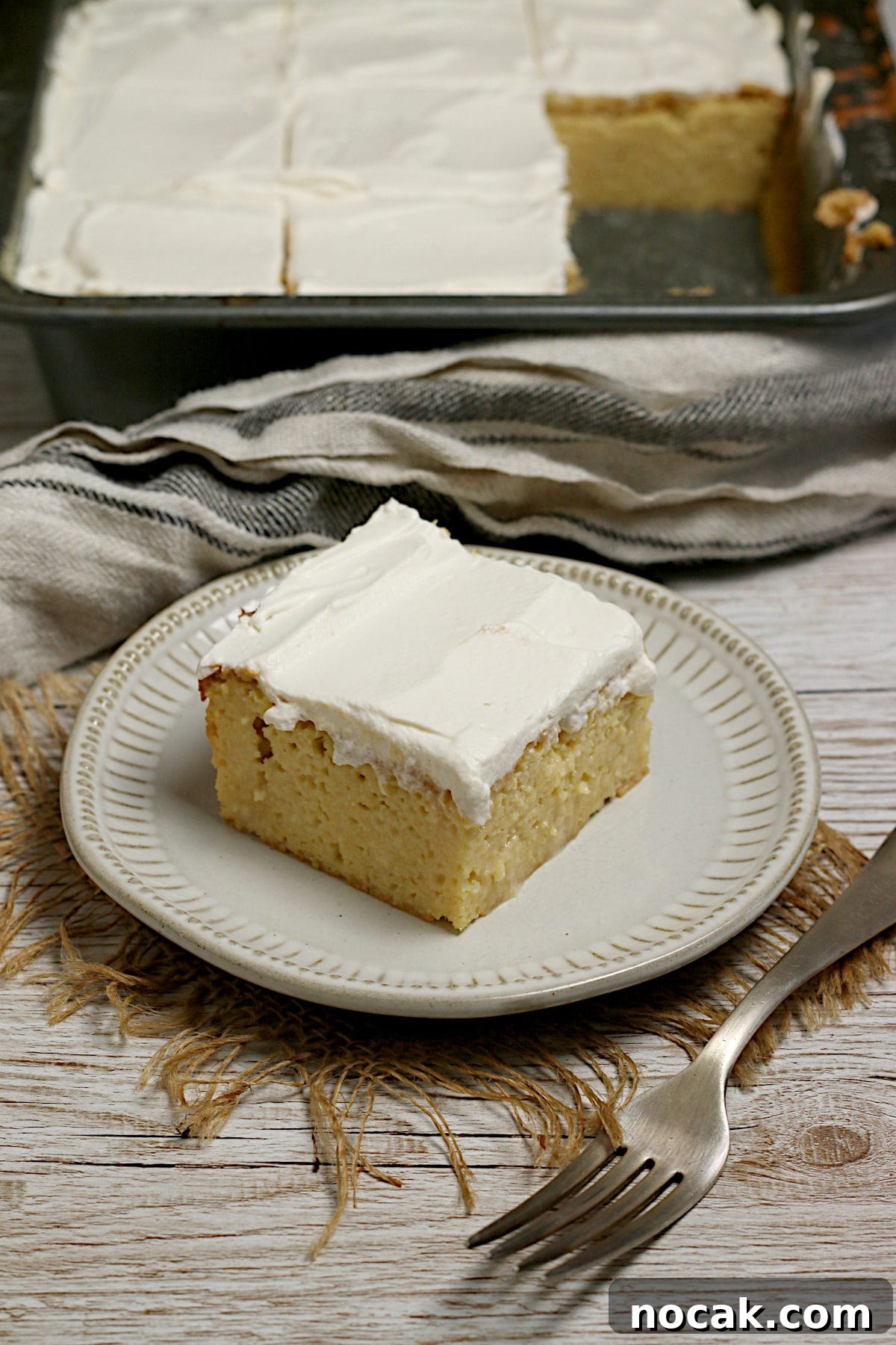 Gluten-Free Corn Tres Leches Cake Recipe for Moist, Flavorful Dessert 2 A slice of Gluten-Free Corn Tres Leches Cake on a small white plate.