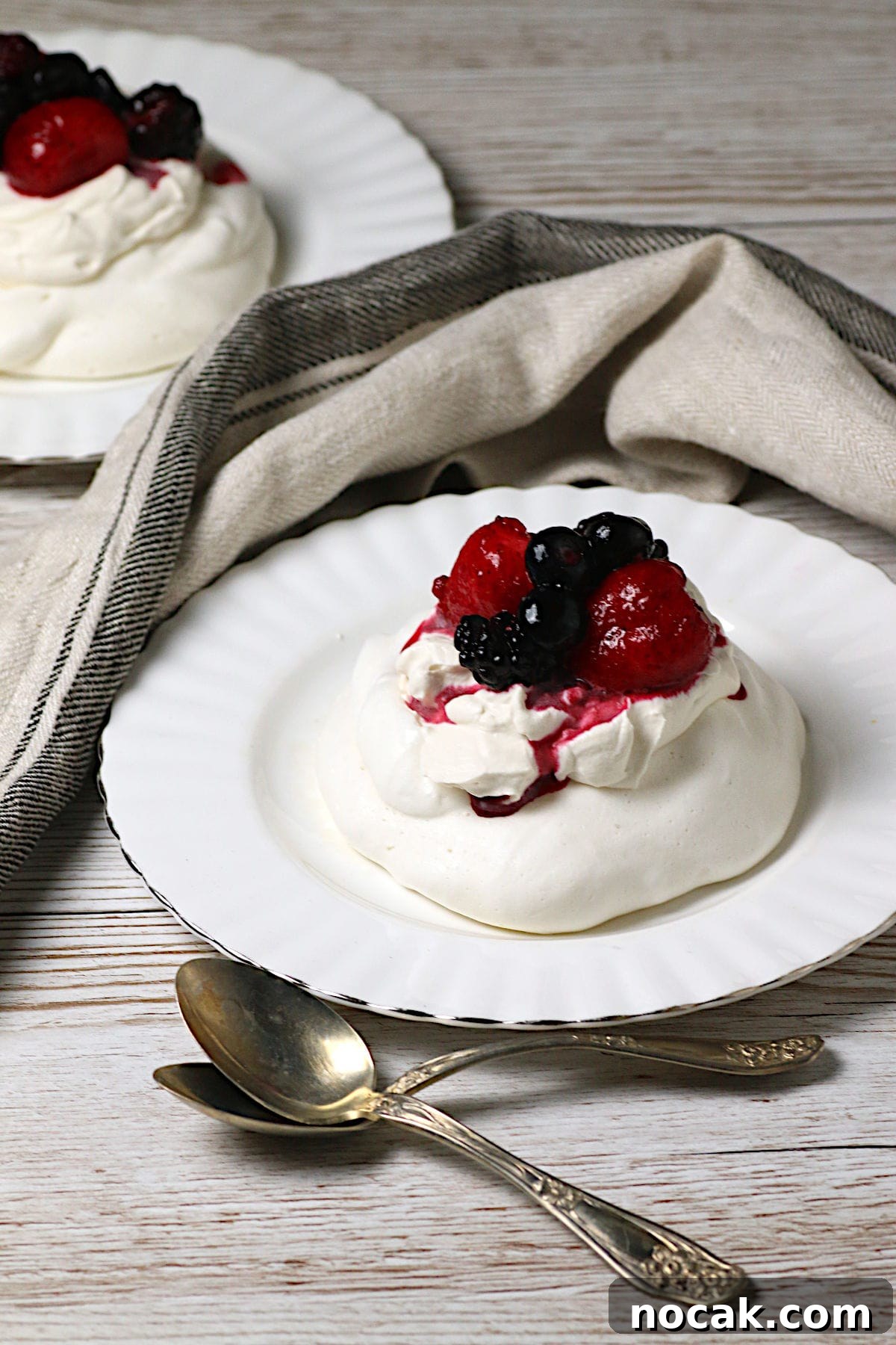 Gluten-Free Corn Tres Leches Cake Recipe for Moist, Flavorful Dessert 7 Mixed Berry Pavlova on a white plate.