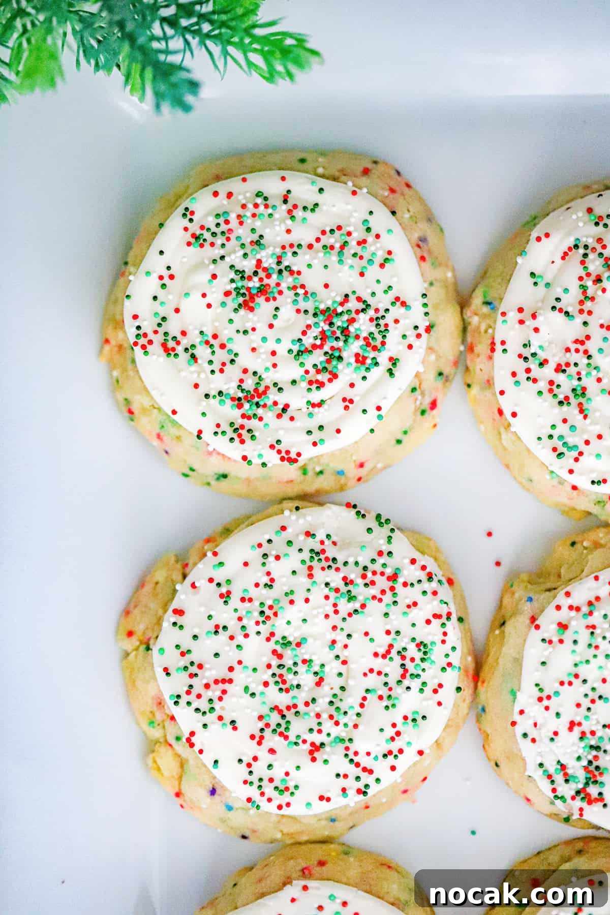 Christmas Sugar Crumble Cookies Recipe: Festive Soft & Chewy Cookies 2 frosted christmas sugar crumbl cookies with sprinkles