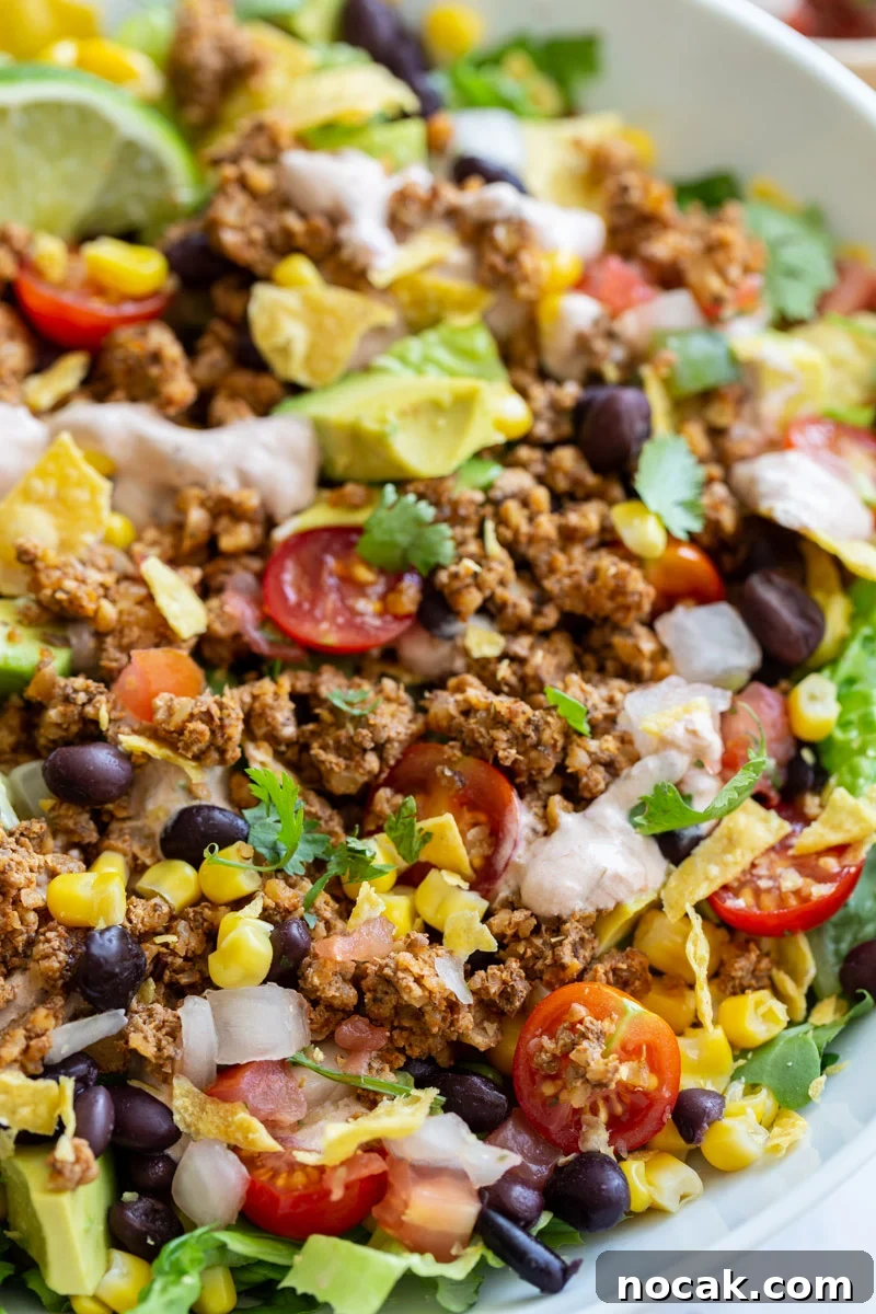 Walnut Taco Filling: Savory Plant-Based Meat Substitute for Tacos 2 vegetarian taco salad loaded with lettuce, tomato, avocado, walnut meat, and a cream sauce