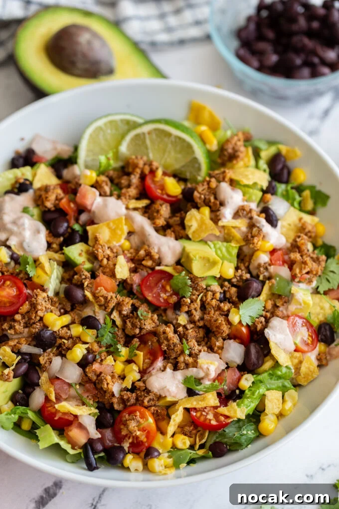 Walnut Taco Filling: Savory Plant-Based Meat Substitute for Tacos 4 vegetarian taco salad loaded with lettuce, tomato, avocado, walnut meat, and a cream sauce