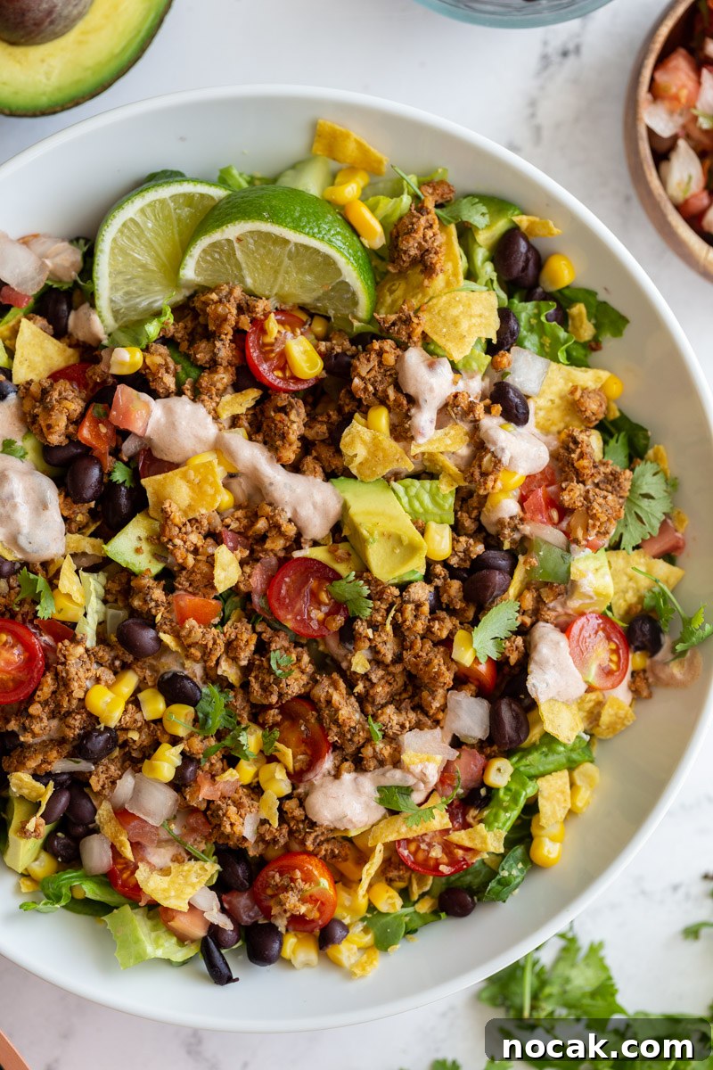 Walnut Taco Filling: Savory Plant-Based Meat Substitute for Tacos 6 vegetarian taco salad loaded with lettuce, tomato, avocado, walnut meat, and a cream sauce