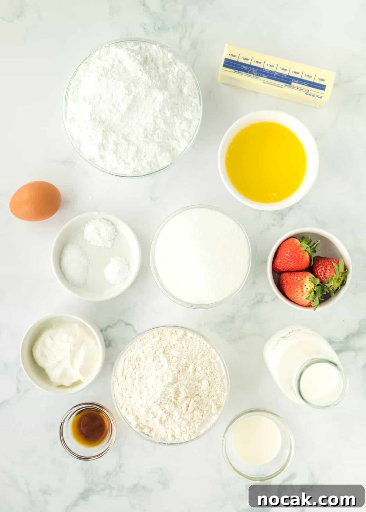 Strawberry Buttercream Frosting Recipe — Smooth, Fresh Flavor 4 Overhead photo of strawberry buttercream cupcake ingredients in individual bowls.