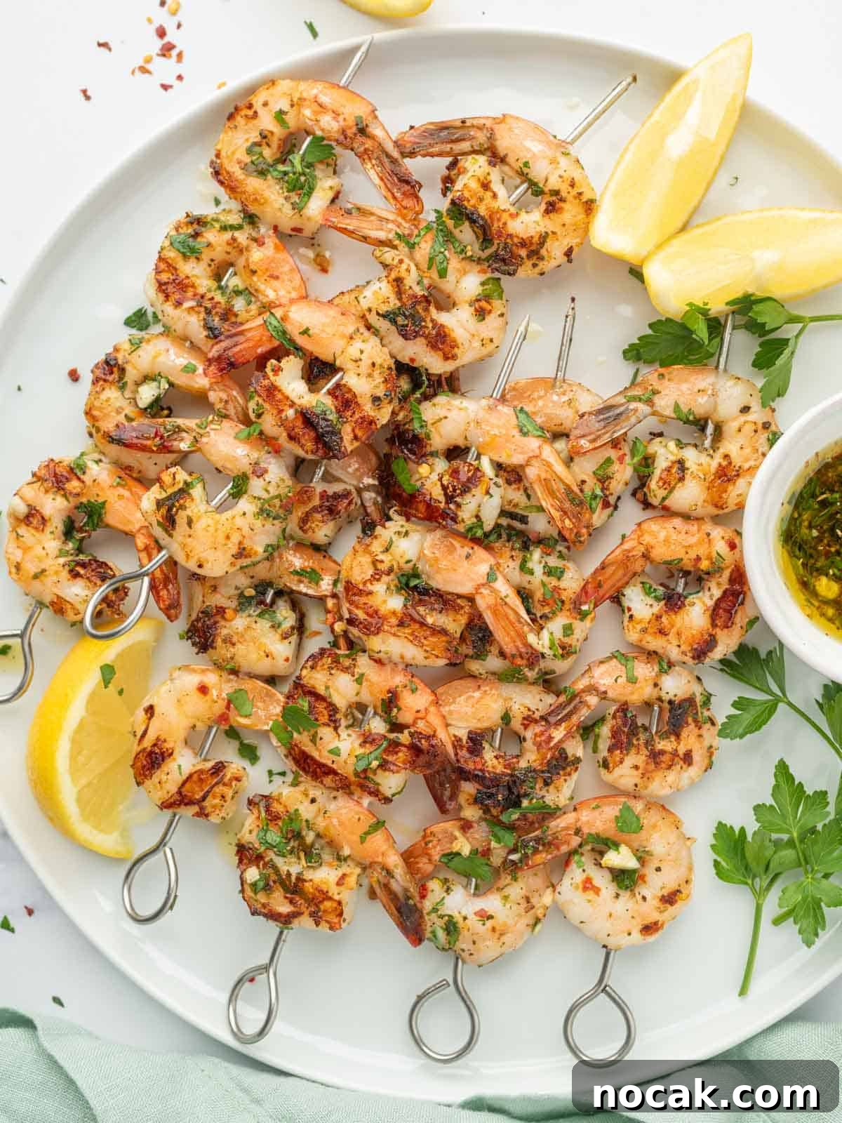 Garlic-Grilled Shrimp Skewers with Zesty Lemon Marinade 2 Garlicky Shrimp kabobs on a platter.