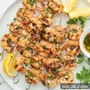 Garlic-Grilled Shrimp Skewers with Zesty Lemon Marinade 9 Garlicky Shrimp kabobs on a platter.