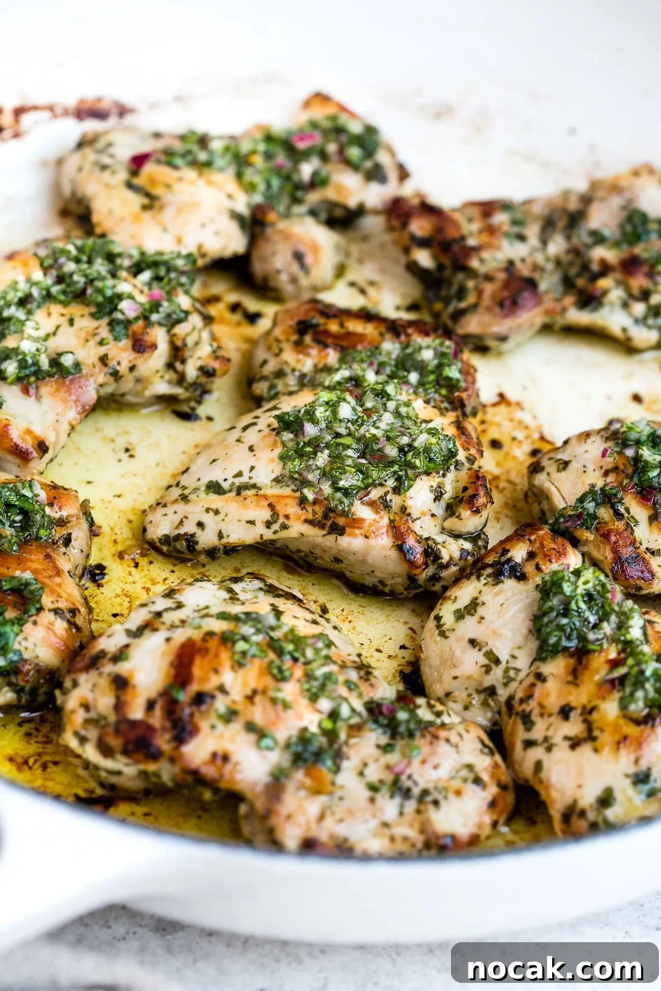 Chimichurri chicken in a large, white skillet.