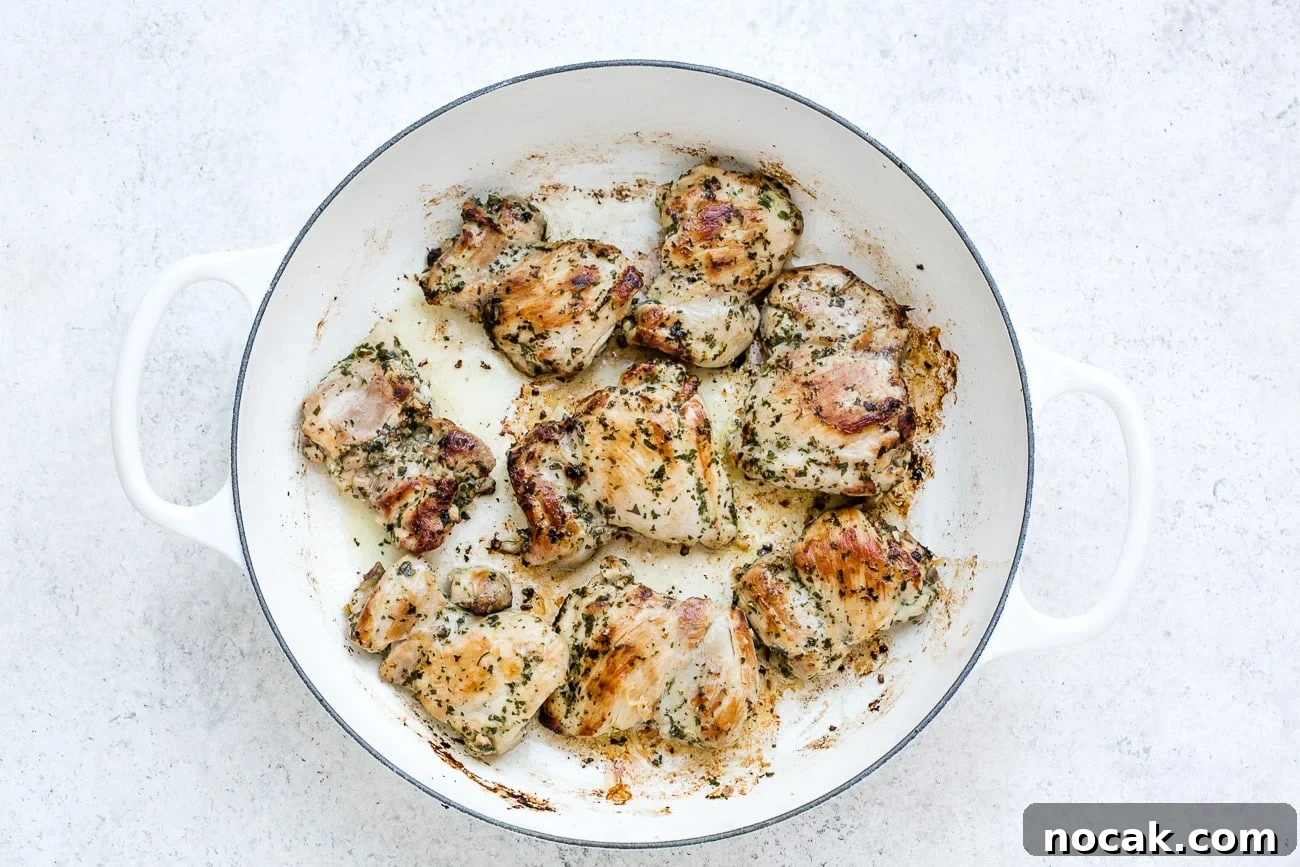 Sautéing chicken in a skillet.