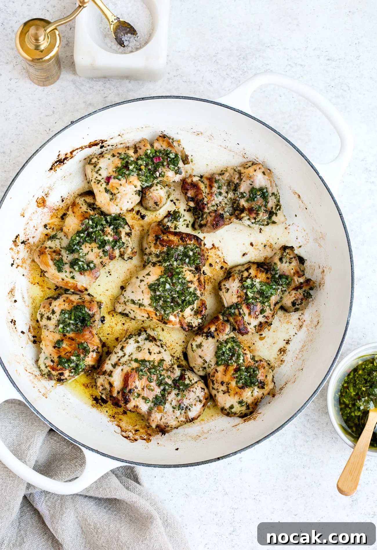 Chimichurri chicken in a large, white skillet.