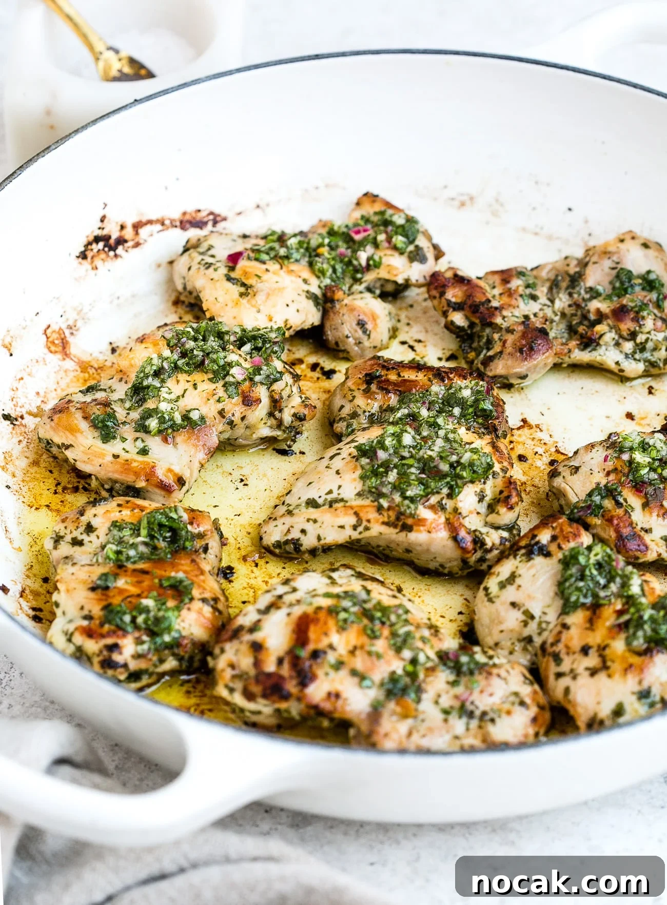 Chimichurri chicken in a large, white skillet.