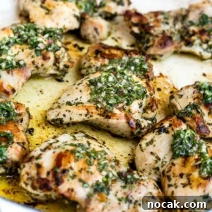 Chimichurri chicken in a large, white skillet.