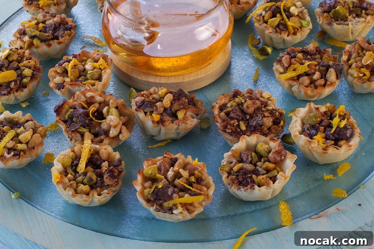 Baklava Phyllo Bites on a blue round wood and glass platter.