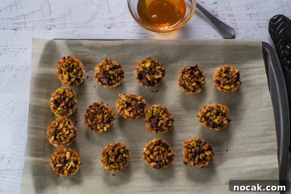 Baked Chocolate Baklava Bites on parchment lined baking sheet.