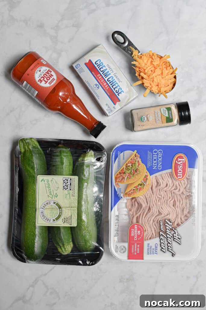 Buffalo Chicken Stuffed Zucchini Boats with Cheesy Filling 3 Ingredients for the Buffalo Chicken Stuffed Zucchini laid out