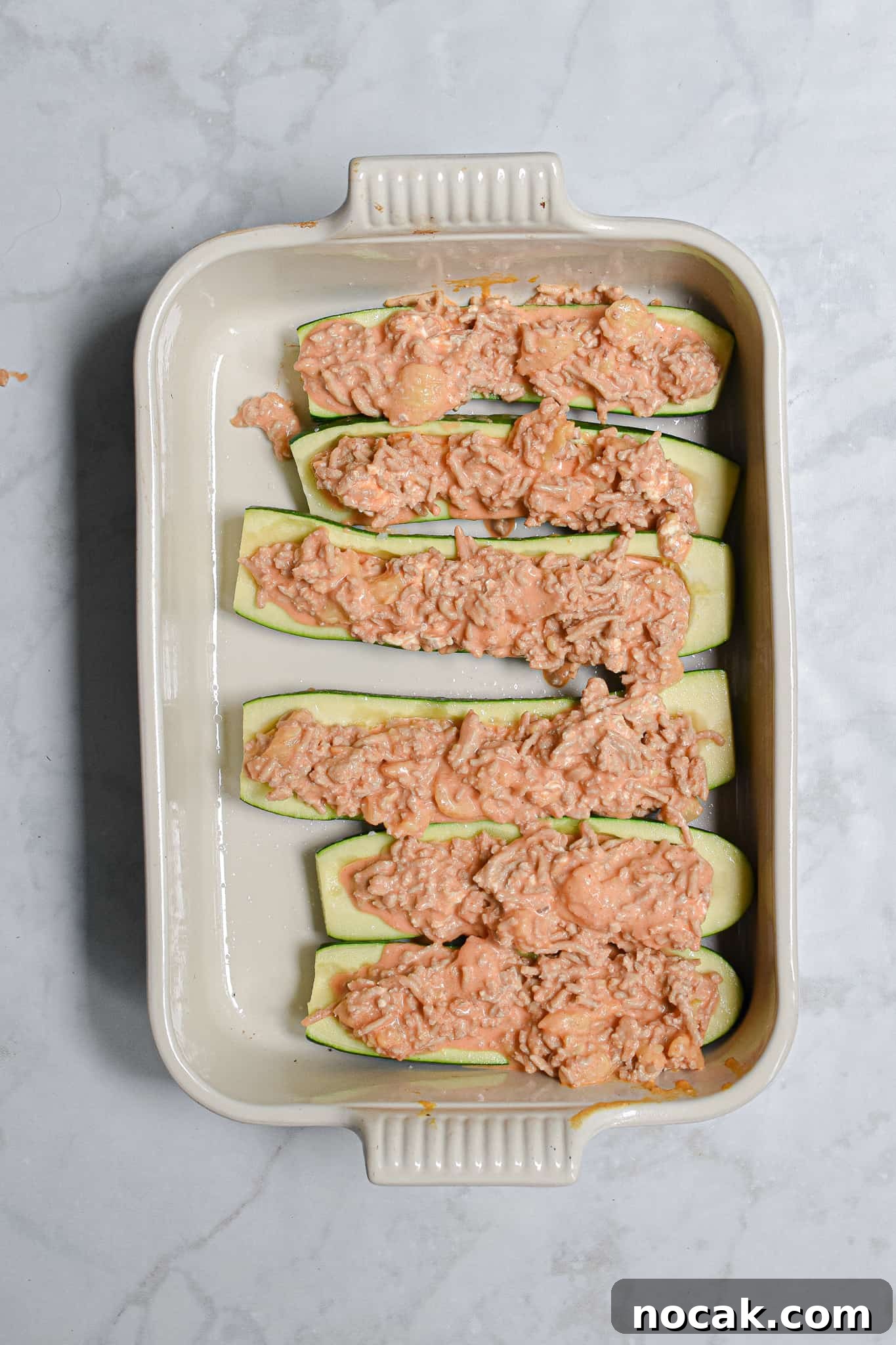 Buffalo Chicken Stuffed Zucchini Boats with Cheesy Filling 7 The filling is added to the buffalo chicken stuffed zucchini