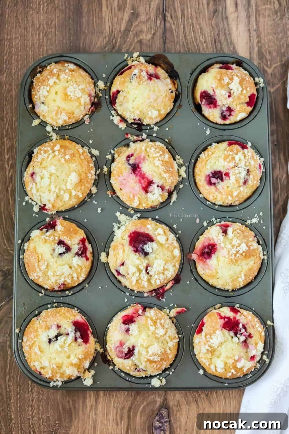Cranberry Orange Muffins Made with Cake Mix 4 overhead view of a muffin tin with freshly-baked cranberry orange muffins for the holidays.