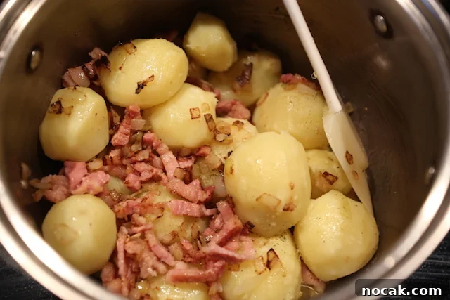 image of boiled baby potatoes with pork in a pot teder whole potatoes