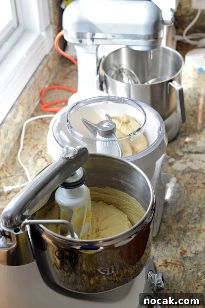Stand Mixer Reviews: KitchenAid, Bosch, Ankarsrum & Ooni Compared 3 Stand mixers in a line on a countertop.