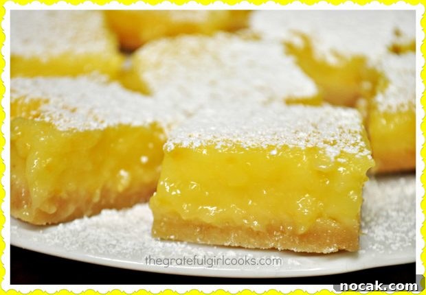 Close up photo of lemon bars on a white plate.