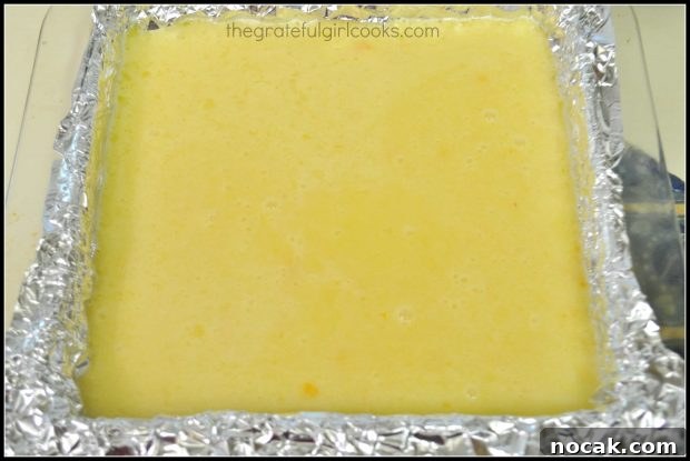Lemon filling is poured onto crust in baking dish and baked