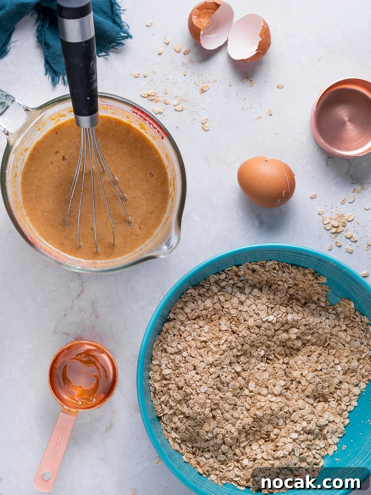 Peanut Butter Baked Oats with Maple and Banana 6 wet ingredients in a liquid measuring cup and dry ingredients in a large blue bowl