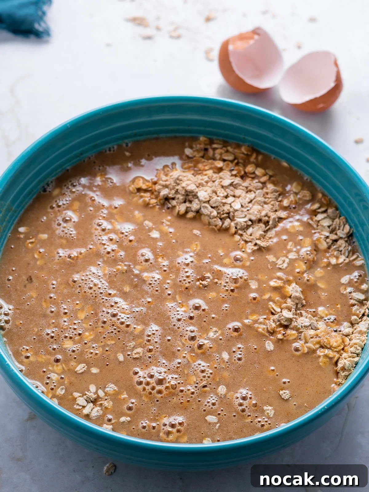 Peanut Butter Baked Oats with Maple and Banana 7 wet and dry ingredients mixed together in the blue bowl