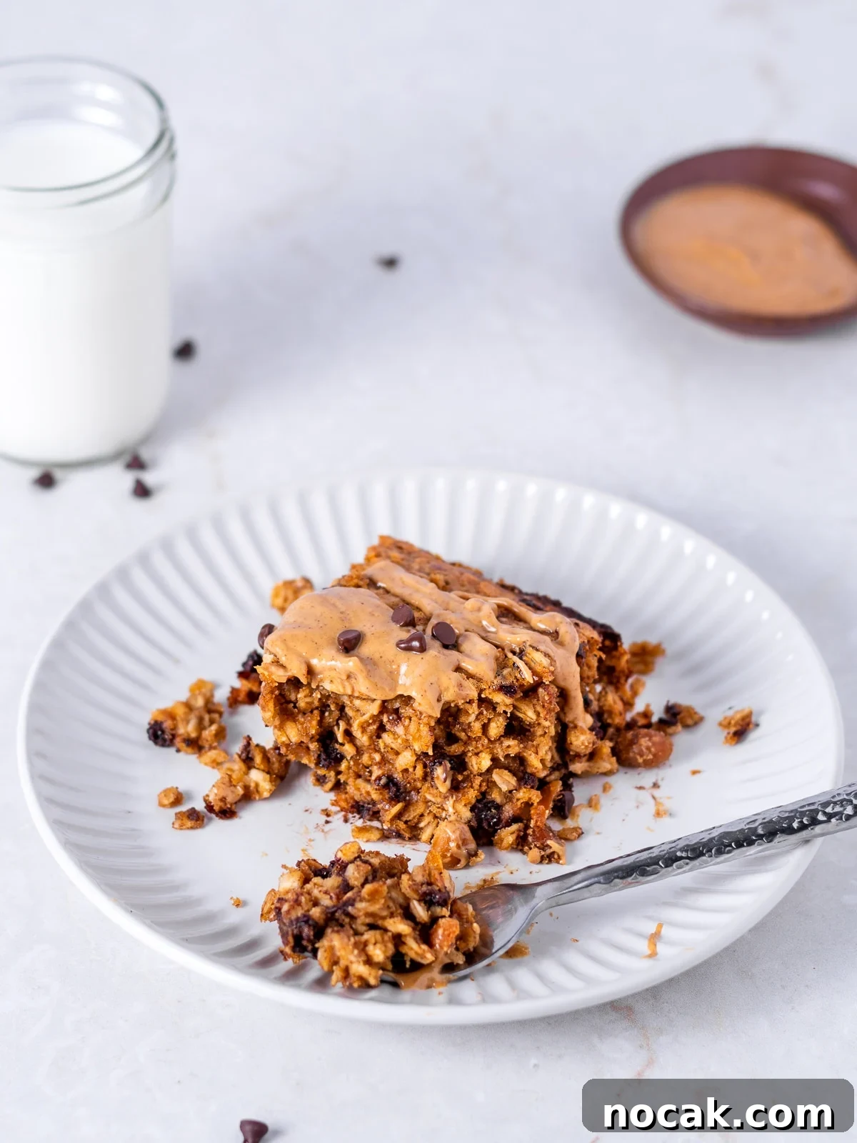 Peanut Butter Baked Oats with Maple and Banana 10 bite of peanut butter baked oatmeal on a fork