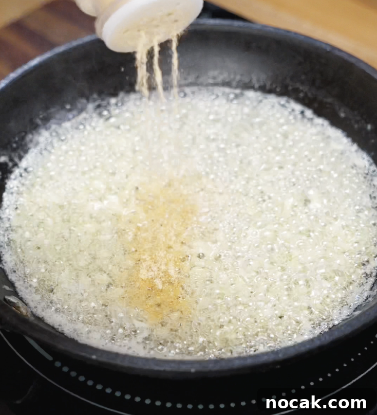Crispy Garlic Parmesan Chicken Tenders Recipe 7 Garlic powder is added to bubbling melted butter in a skillet to build the rich and aromatic garlic butter sauce.