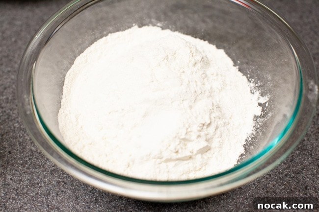 Mixing flour and salt Flour and salt mixed together in glass bowl