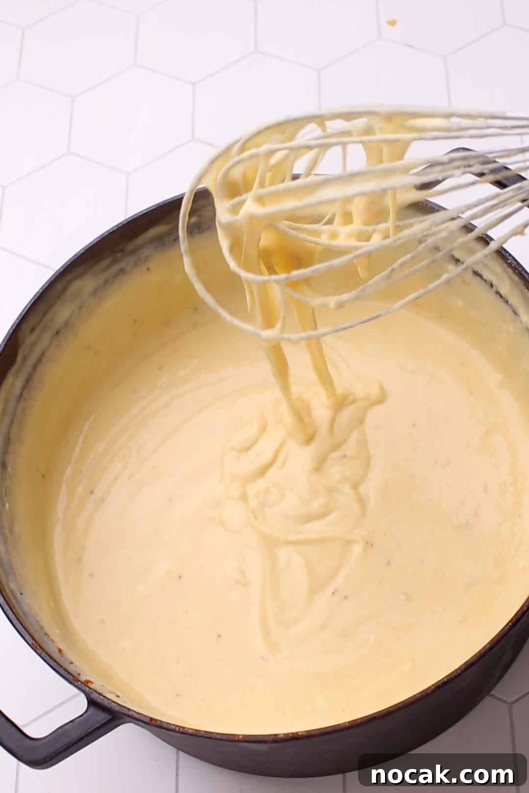 Creamy Cheese Sauce Recipe for Mac and Cheese 12 Whisking cheese sauce for mac and cheese.