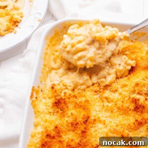 Creamy Cheese Sauce Recipe for Mac and Cheese 13 Old Fashioned Baked Macaroni and Cheese with a spoon scooping some out.