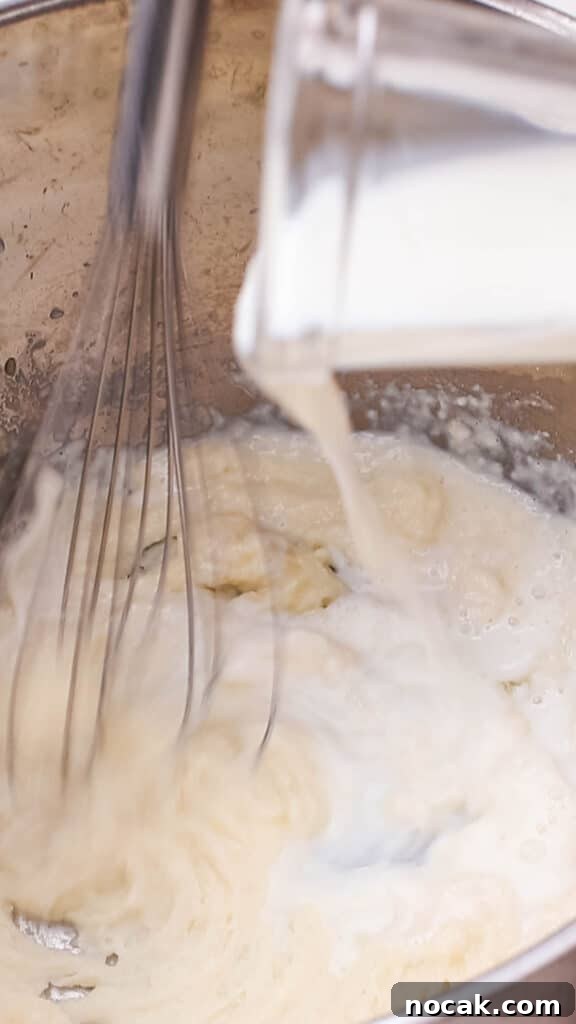 Creamy Cheese Sauce Recipe for Mac and Cheese 7 Adding milk to butter and flour mixture in saucepan.