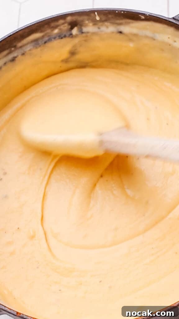 Creamy Cheese Sauce Recipe for Mac and Cheese 10 Stirring cheddar cheese sauce for maroni and cheese.