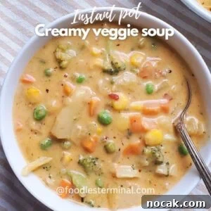 Creamy Vegetable Soup Recipe: Comforting Weeknight Meal 12 creamy veggie soup in a white bowl with a spoon