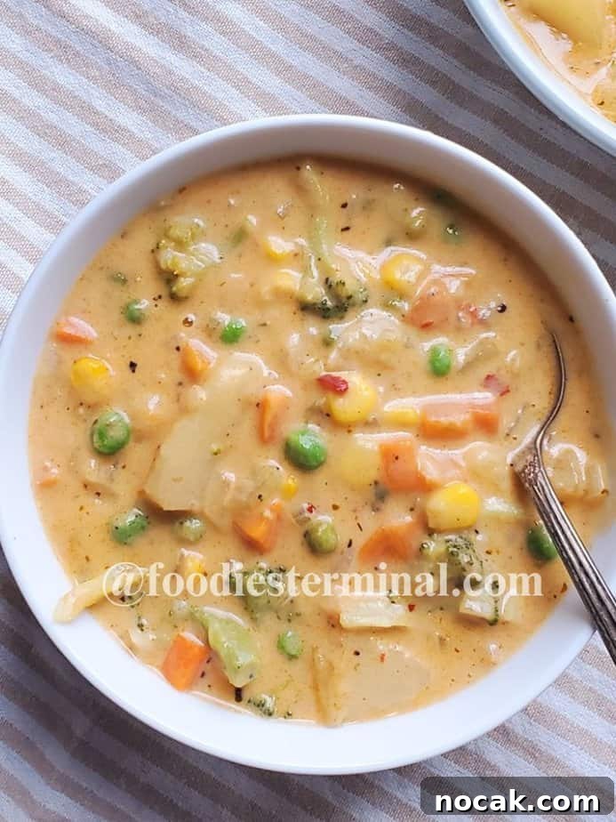 Creamy Vegetable Soup Recipe: Comforting Weeknight Meal 8 easy creamy vegetable soup in a white bowl with a spoon