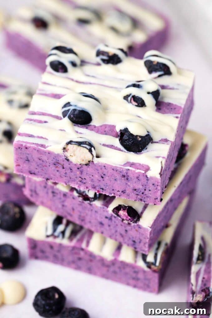 Creamy No-Bake Blueberry Fudge Recipe 11 Purple blueberry fudge topped with white chocolate.