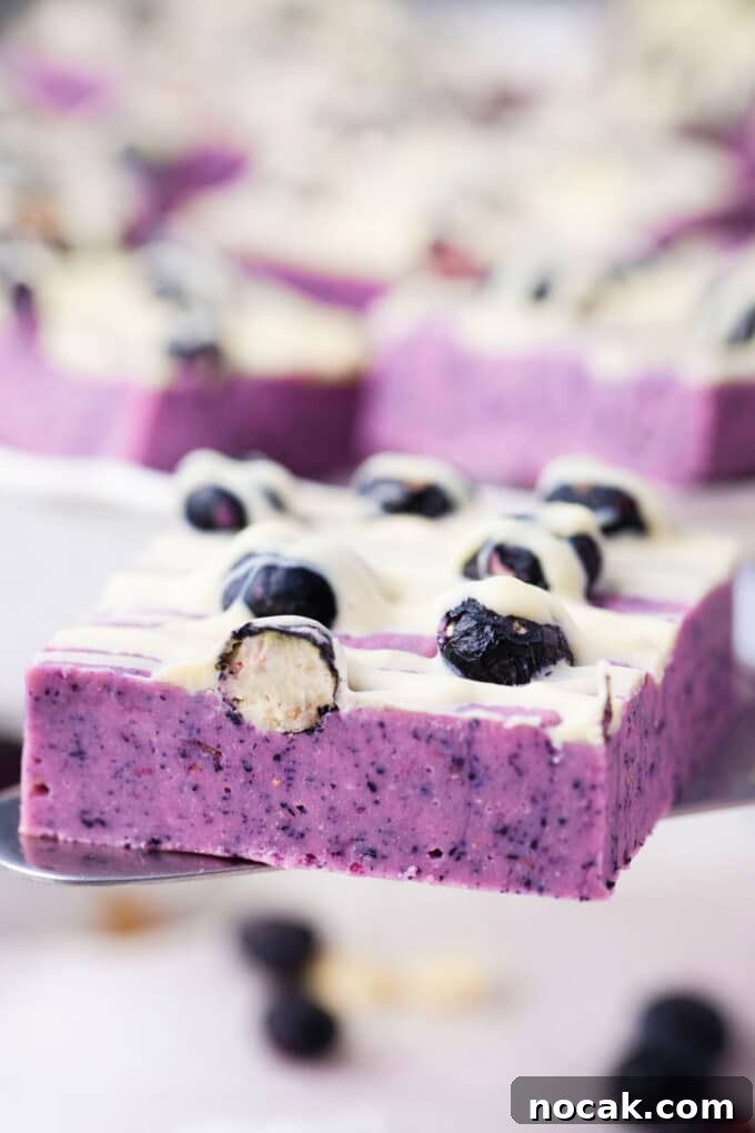 Creamy No-Bake Blueberry Fudge Recipe 12 A piece of blueberry fudge on a serving spatula.