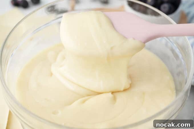 Creamy No-Bake Blueberry Fudge Recipe 6 A bowl of melted white chocolate.