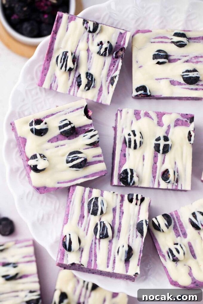 Creamy No-Bake Blueberry Fudge Recipe 10 Overhead shot of blueberry fudge pieces on a plate.